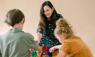 Angela playing magnet tiles with children